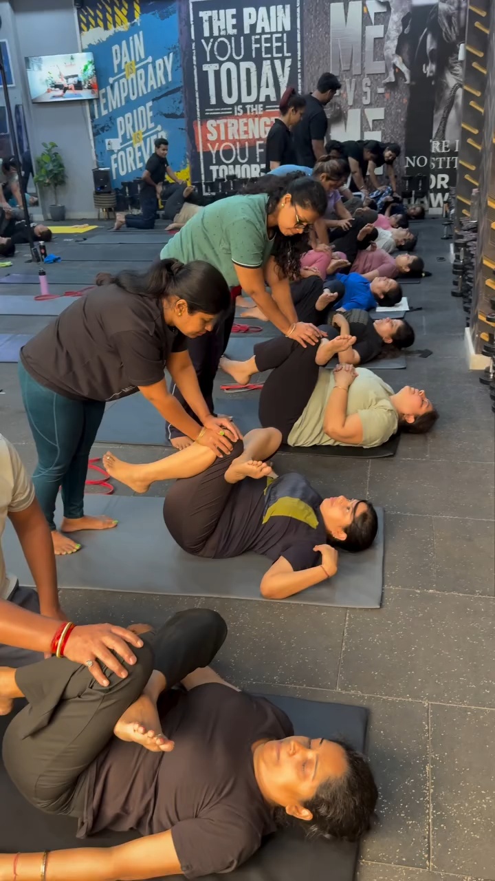 Partners assisting a group stretching exercise at The Sumit’s Style